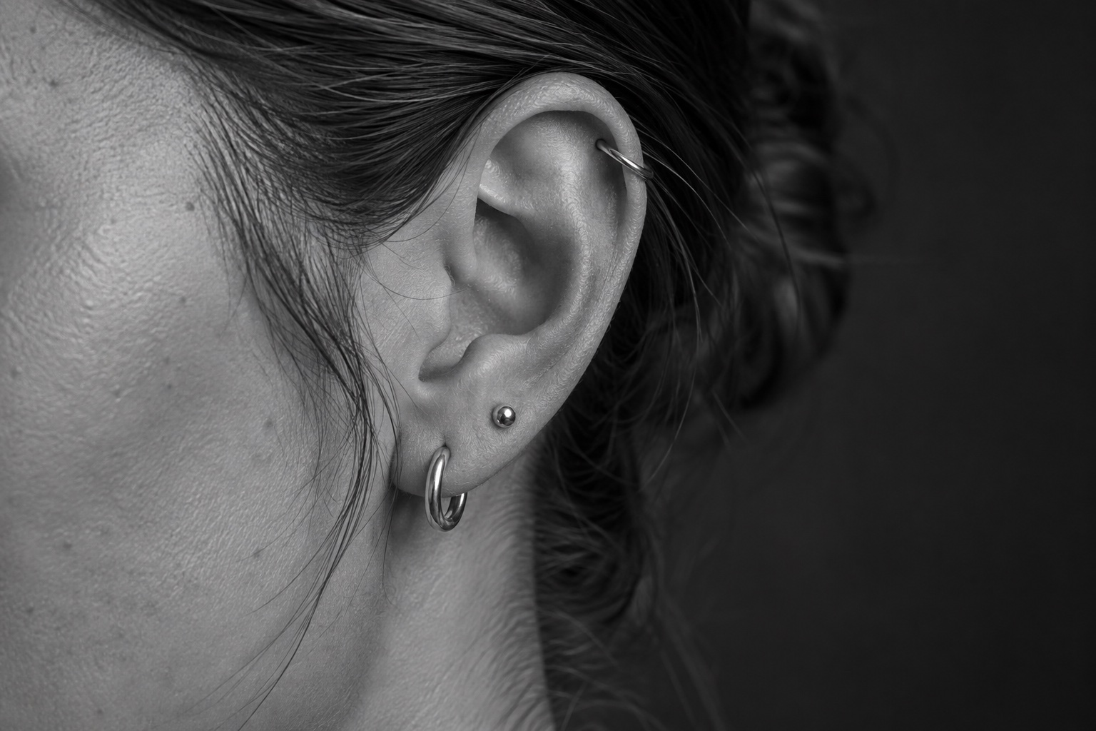 Titanium hoop and stud jewelry in healed ear piercings